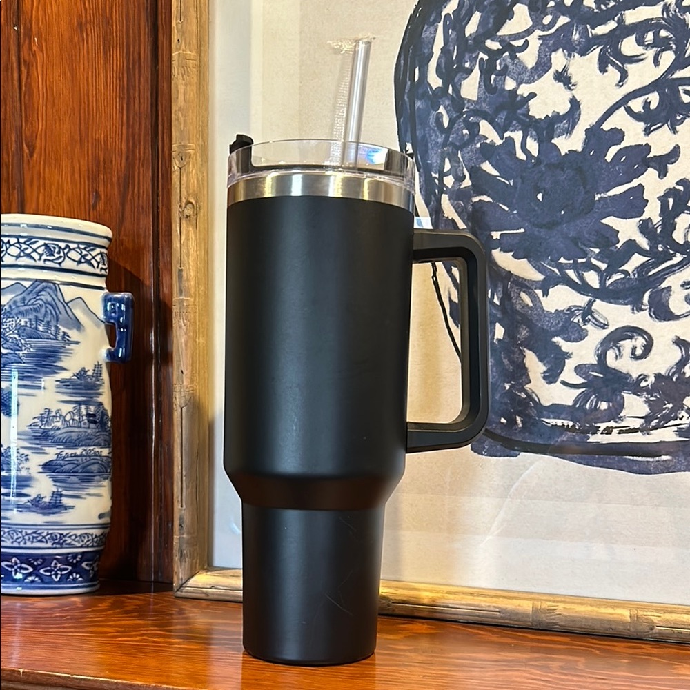 40 oz black tumbler with straw. Never been used. Great gift!